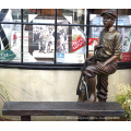 outdoor life size bronze sculpture of a caddy with a bench